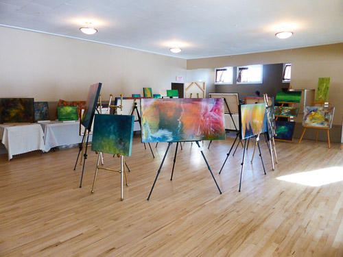 marie gelinas giles abstract acrylic paintings with CAC on easels in center of room